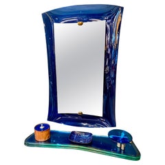 Fontana Arte blue mirror with glass console. Italy 1970