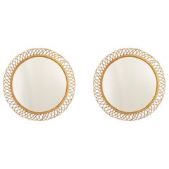 Pair of round rattan mirrors with interlacing. 1980s.