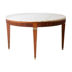 Extraordinary four-legged table with brass capitals and tips