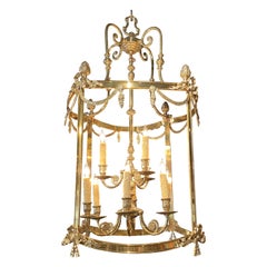 Lantern Form Nine Light Chandelier in Brass with Scroll & Ribbon Swag Decoration