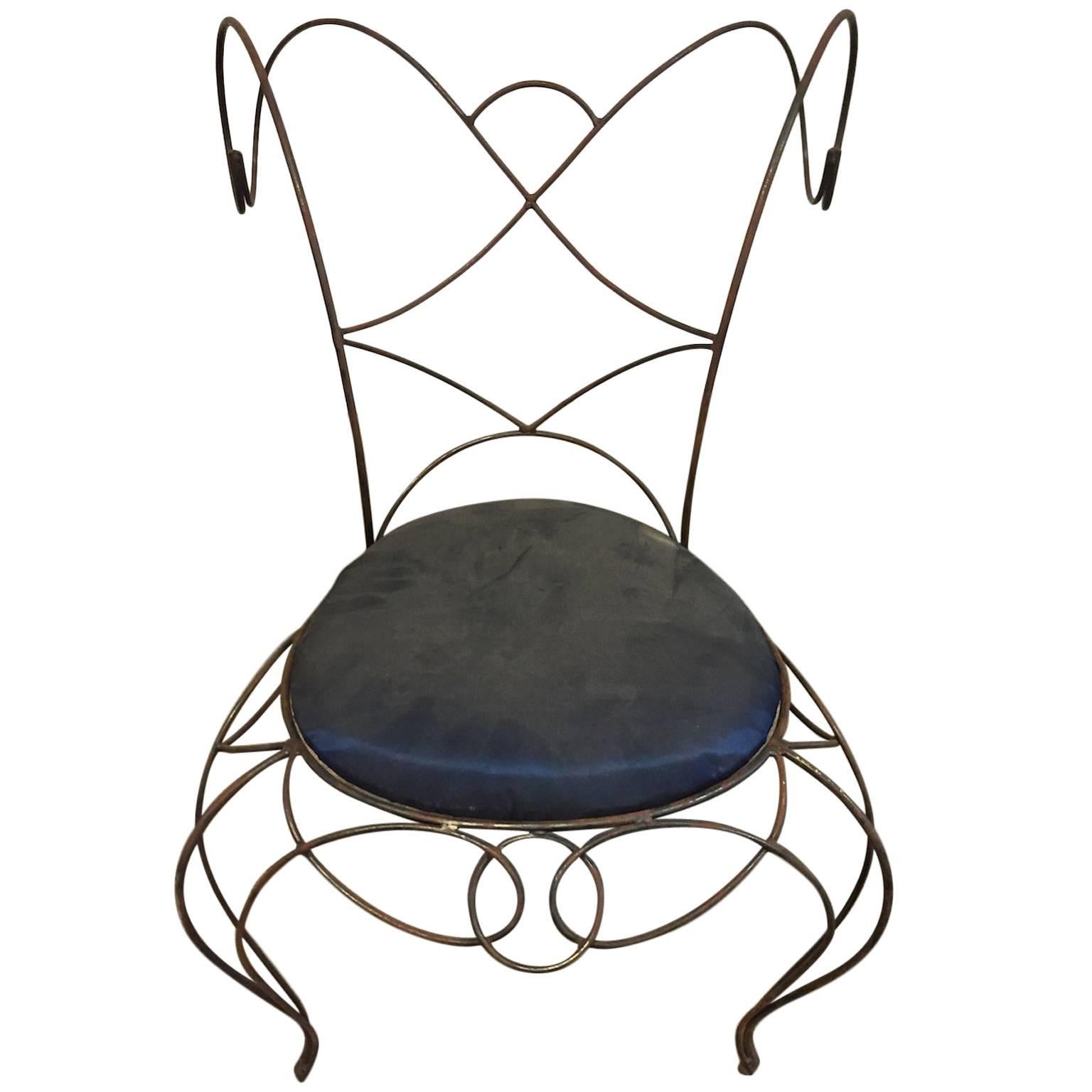 Wrought iron chair made of coilings. 
Fabric seat.