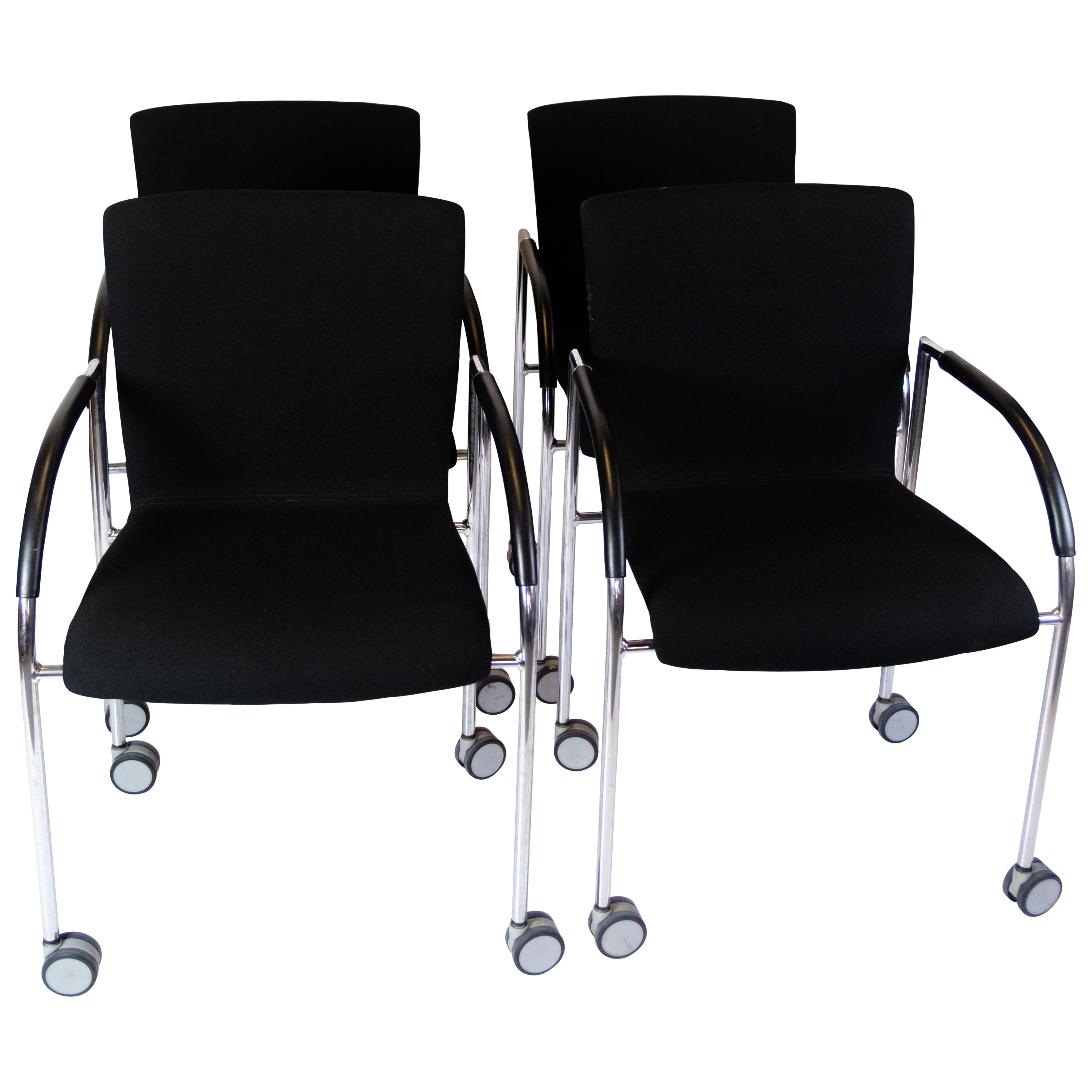 Set Of Four Office Chairs In Black Fabric With Wheels