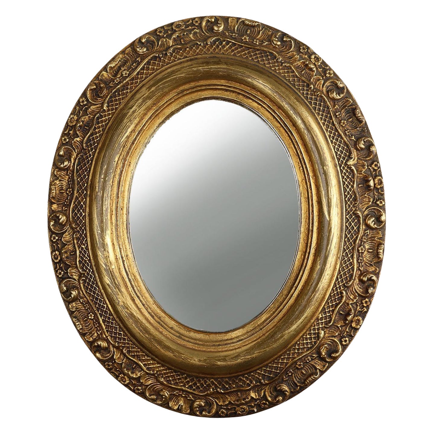 French Baroque style oval mirror in gilded wood with floral decorations