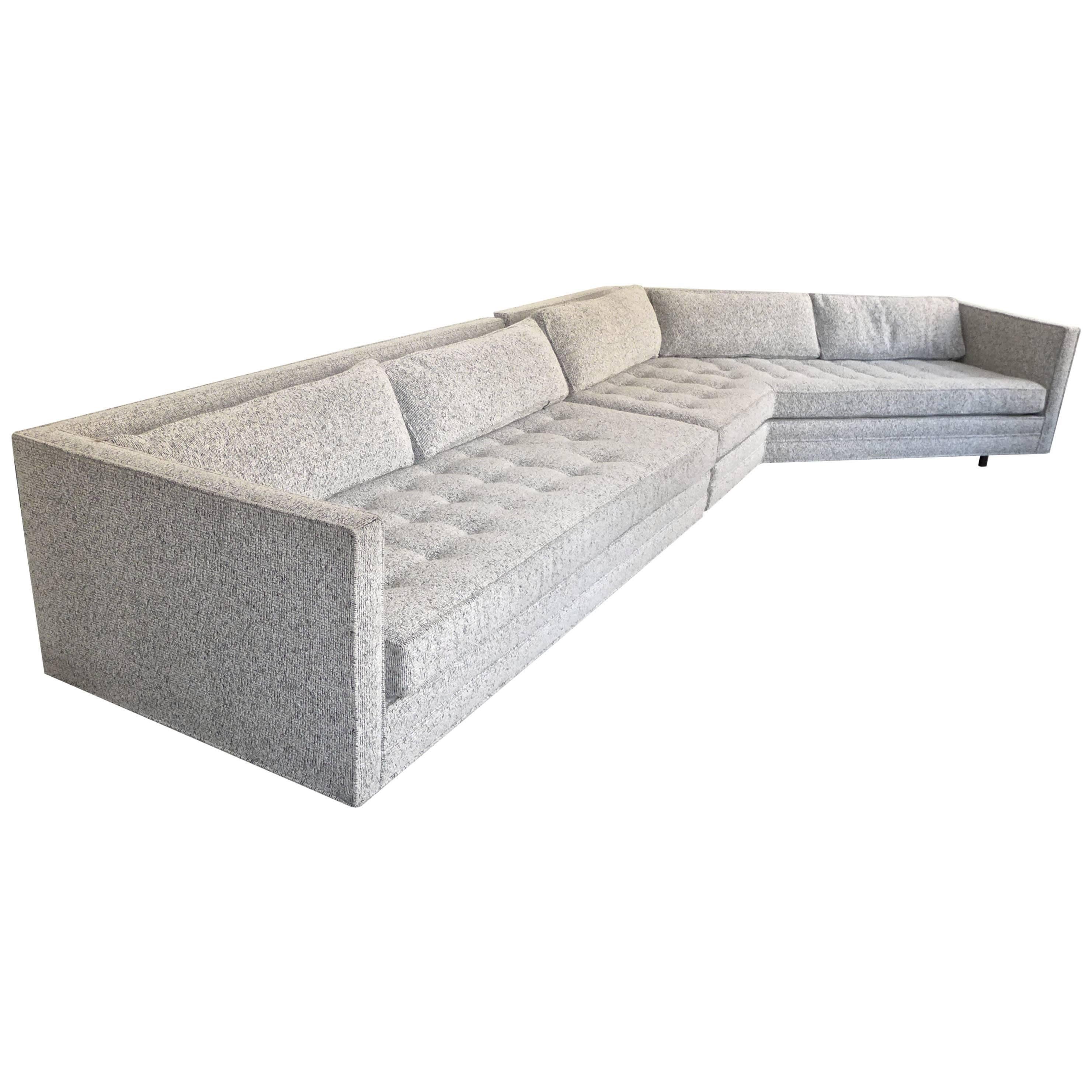 Two-piece sectional sofa with angled section and recessed mahogany cylindrical legs. Designed by Harvey Probber and made circa 1960s. With even arms, tufted seat cushions and five loose cushions on the back. A well-tailored, nicely proportioned and