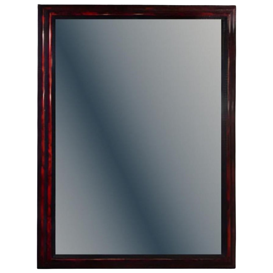 A large French ripple carved and faux tortoiseshell cushion mirror.