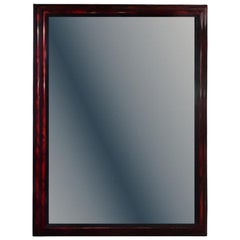 A large French ripple carved and faux tortoiseshell cushion mirror.