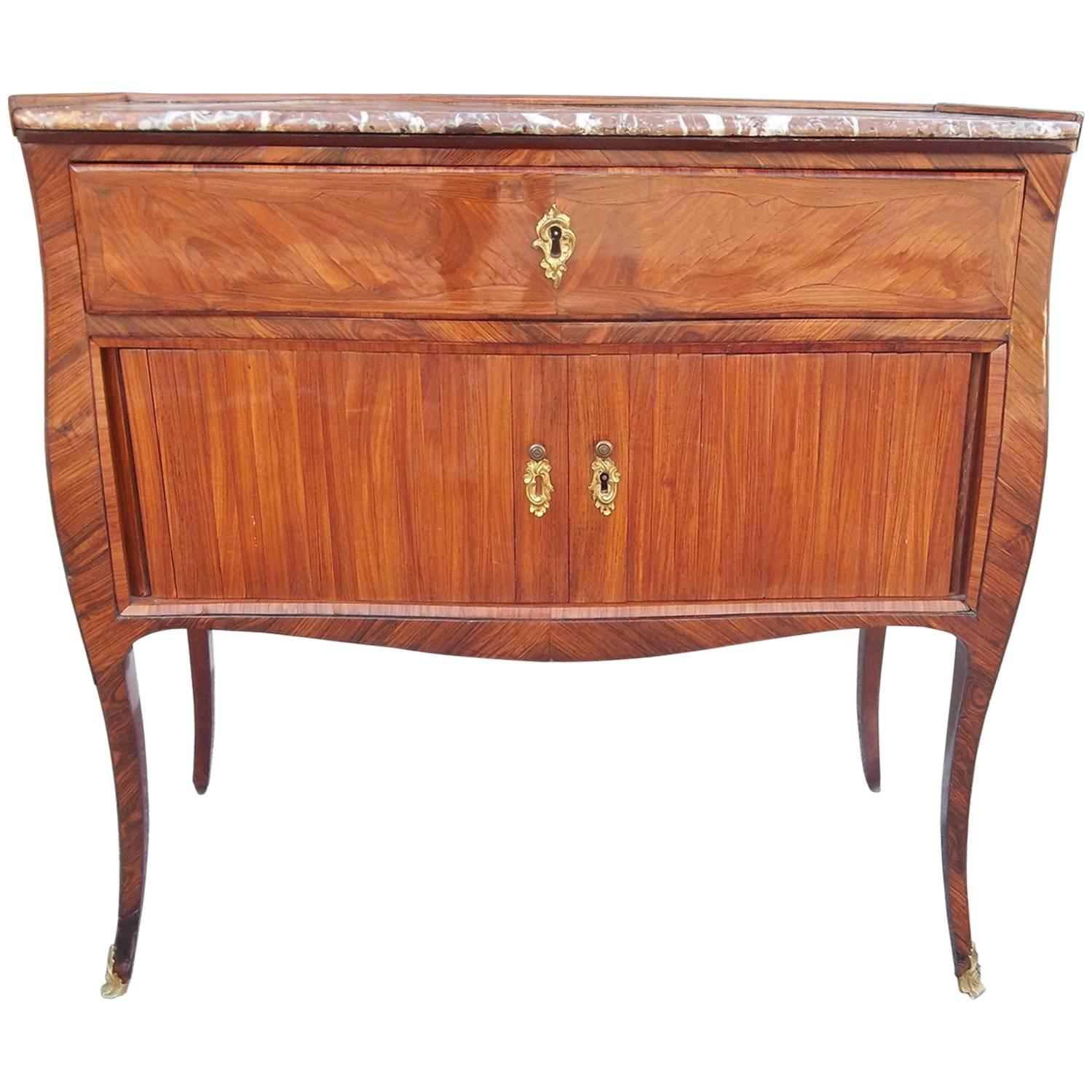 With tambour doors (in fine working condition). The cabinet with inset marble-top. The top drawer with hand hewn dove tailing in 18th century manner. Each end with well defined tulips (pattern in the veneer). Excellent color and patina. 
Very well
