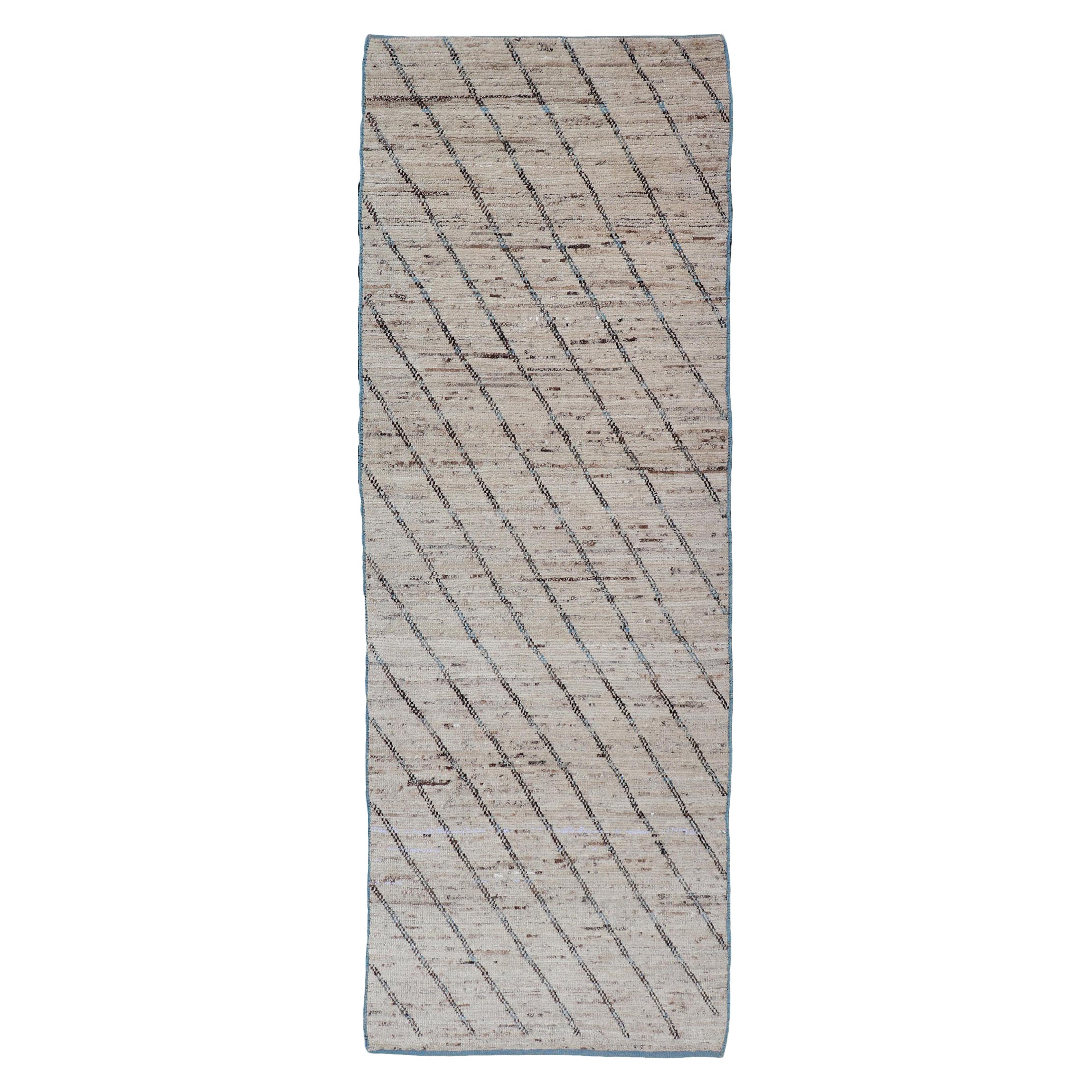 Tapis de course moderne noué à la main en laine avec am designs linéaires dans des tons bleus et neutres