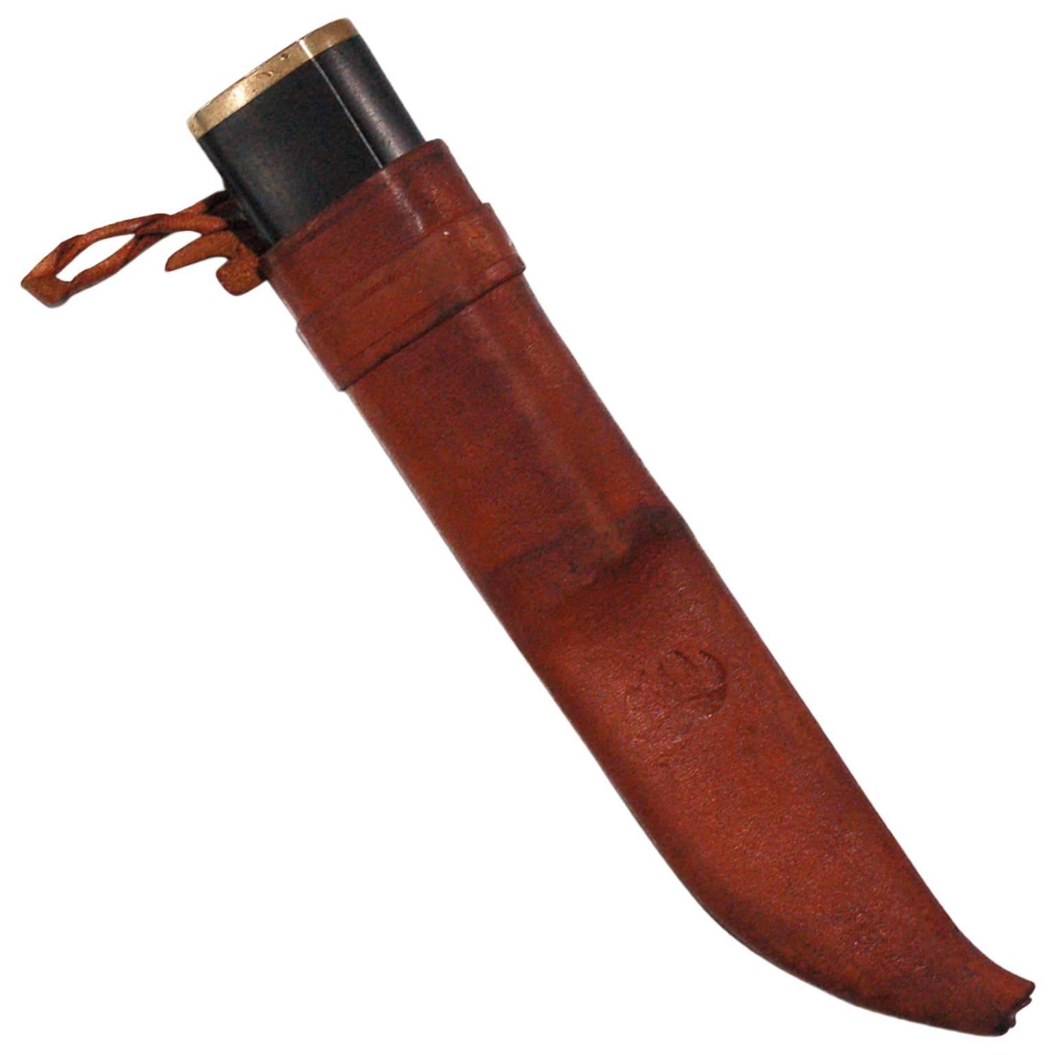 Stainless steel blade, black nylon handle with brass fittings and leather sheath.
Sheath has the bear claw impression and blade marked, with manufacturer's info and artist name. Made by Hackman.