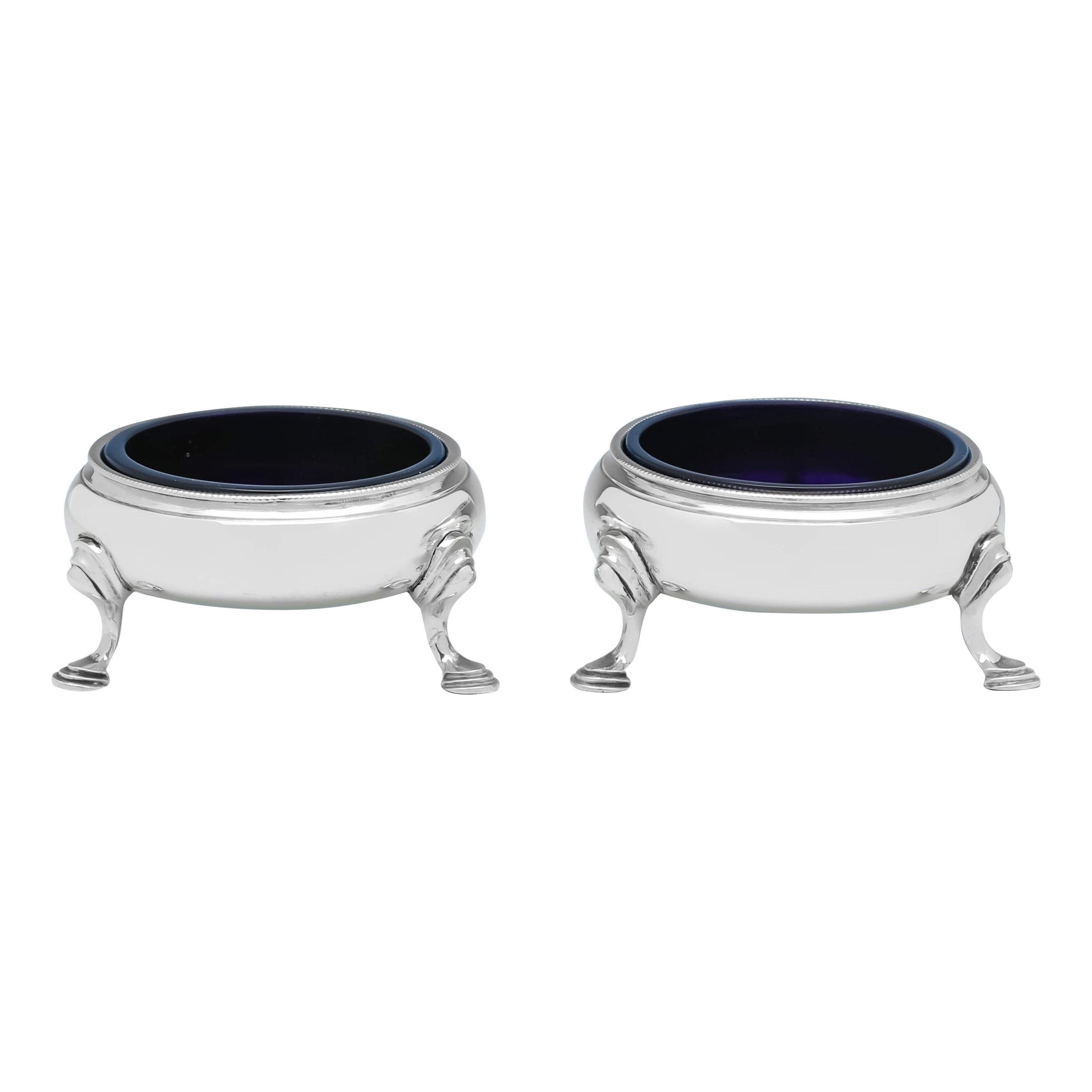 Pair of George III period sterling silver salt cellars with blue glass liners