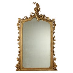 Grand miroir sculpté et doré de la période ombertine