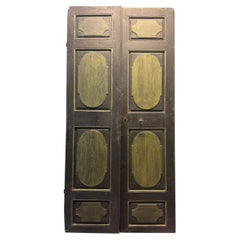 Antique Lacquered wooden door, two leaves, panels carved with geometric figures, Italy