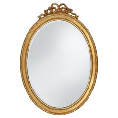 Oval shaped carved gilded Baroque mirror with beveled glass, Belgium