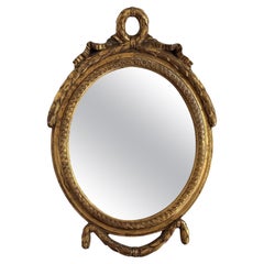 Antique 20th Century French Gilt Oval Mirror With Ribbon Crest