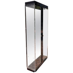 A large glass curio cabinet with black, brass, and mirrored accents, 20th c.