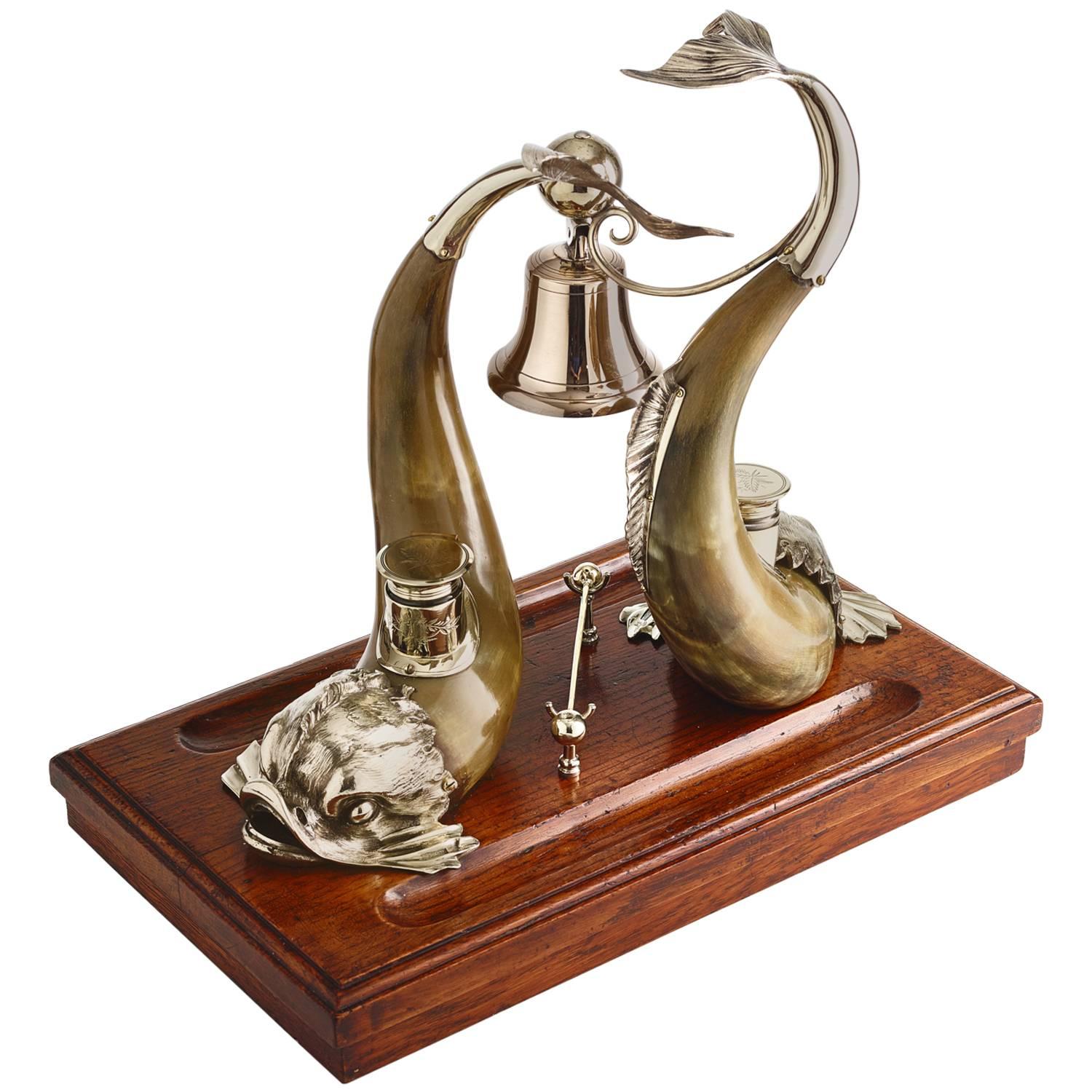 A large and impressive, horn and silver plate ink stand partners desk centrepiece, circa 1910.
It comprises two superb mythical sea creatures in horn and silver-plate and two hinged lid inkwells. 
There is also a bell, which could have been used to