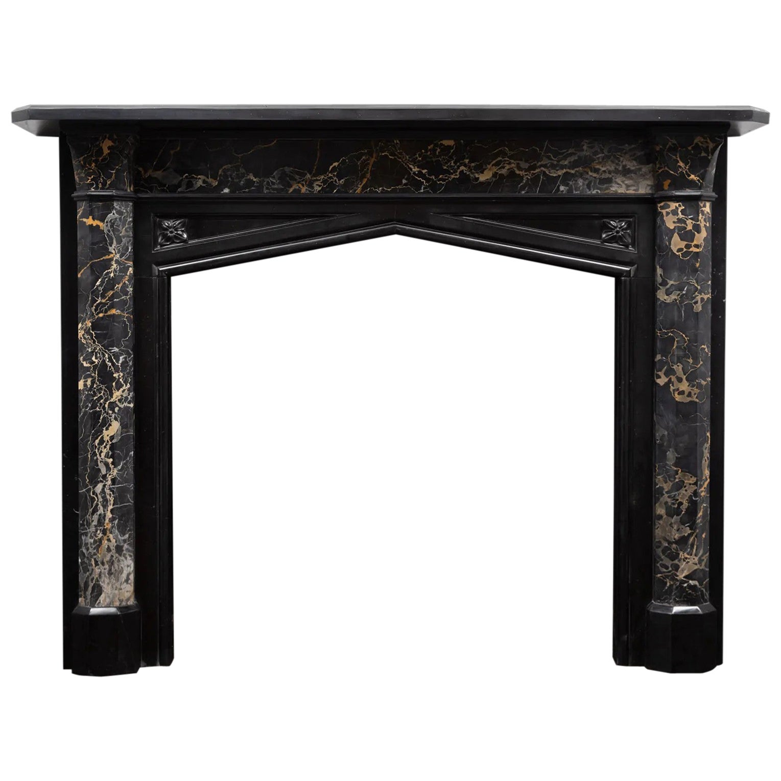 An antique Gothic revival, black marble and portoro marble mantel