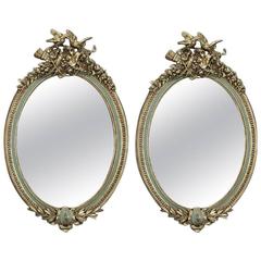 Pair of Early 20th Century French Louis XVI Carved Painted and Gilt Oval Mirrors