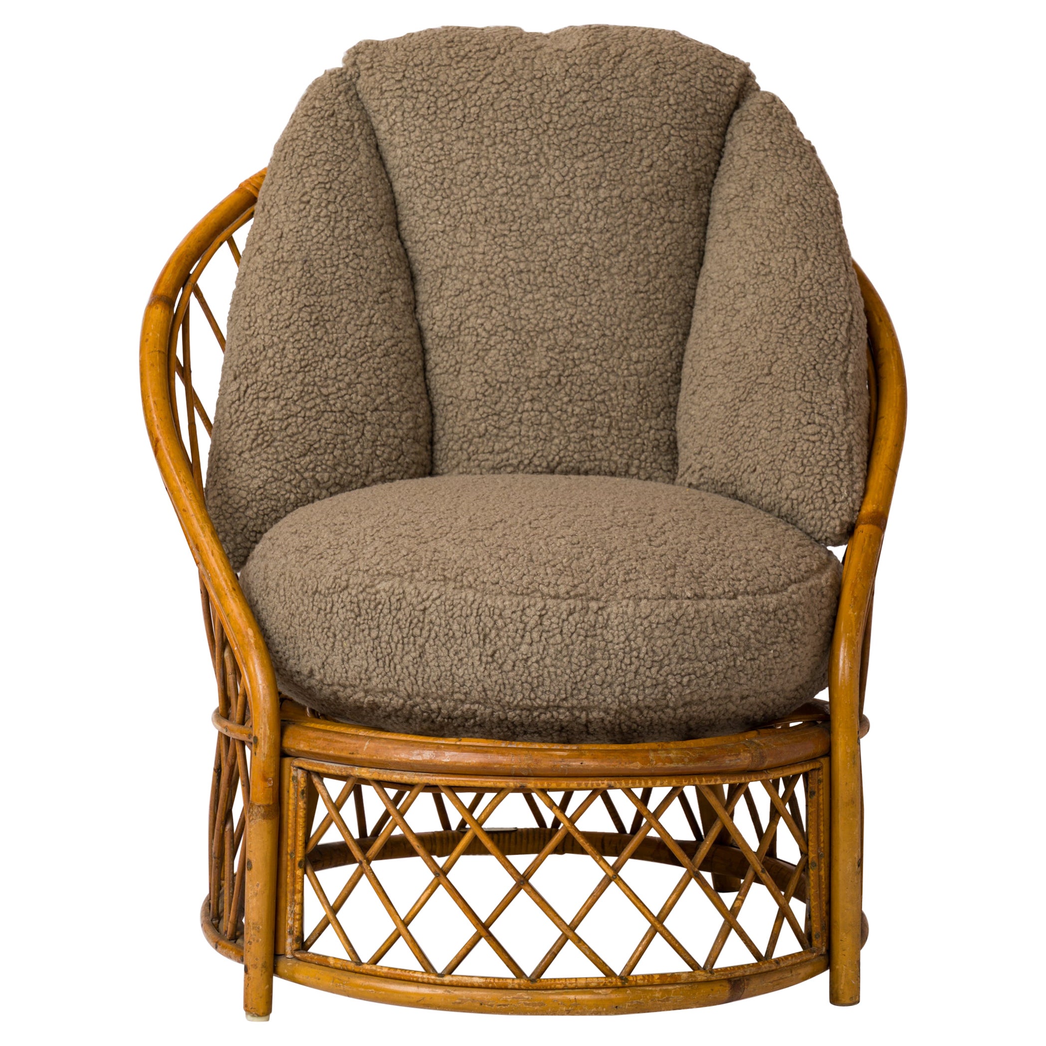 Small, compact rattan armchair. Signed Audoux Minet with mesh-patterned back and base in good vintage condition. 
This chair will ship from France and can be returned to either France or to an upstate NY facility. 
Price does not include shipping