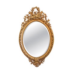 A fine 19th century French Louis XVI oval carved and gilt mirror