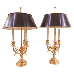 A fine pair of 19th c Louis XVI gilt bronze bouillotte lamps with tole shades