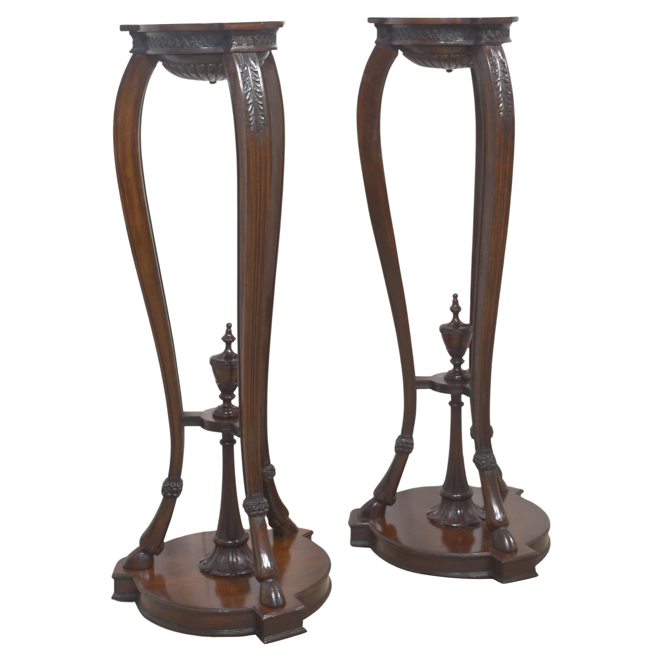 Pair of carved mahogany stands