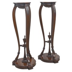Pair of carved mahogany stands