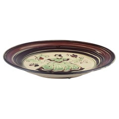 Kähler, Denmark. Large ceramic dish with motif of a dancing woman.
