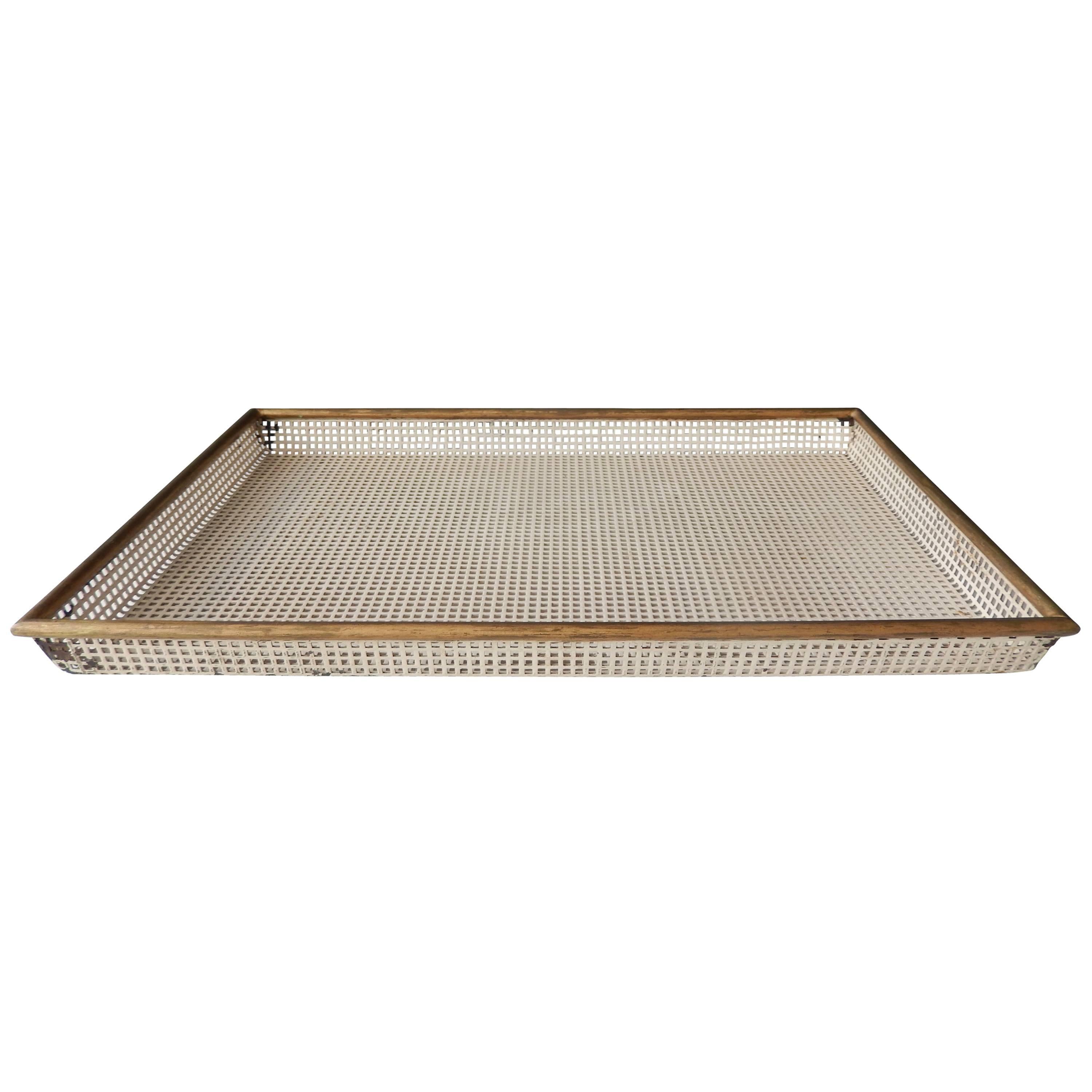 An elegant, modernist tray (plateau fantaisie) by the renowned, Mid-Century French designer Mathieu Matégot (1910-2001). Matégot pioneered the use of perforated sheet metal and lacquered steel in his furniture and decorative objects. Manufactured