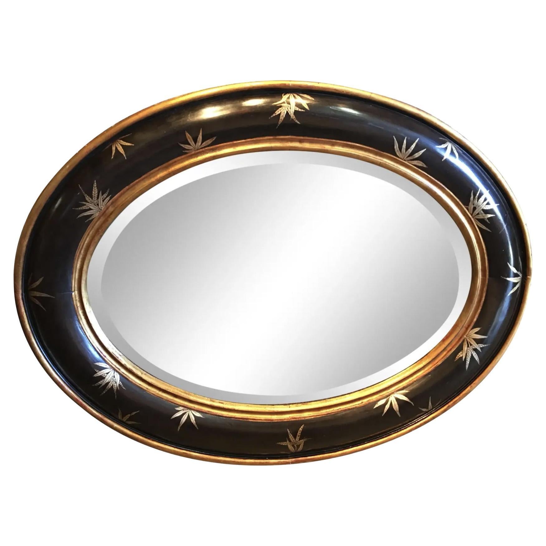Chinoiserie Gold Bamboo Leaves on Black Frame With Antiqued Oval Smoky Mirror For Sale