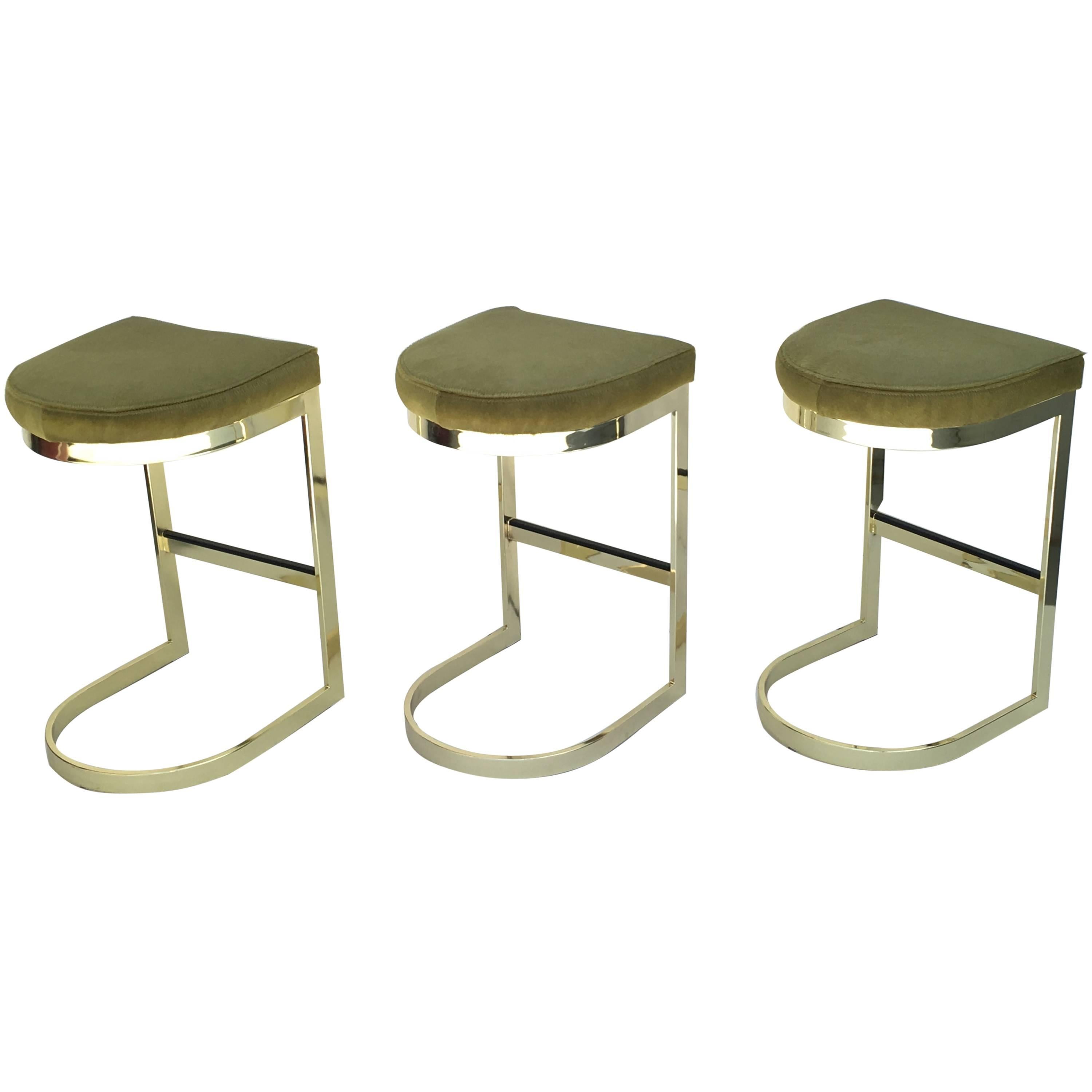 Set of Three Polished Brass and Pony Hide Barstools by Milo Baughman