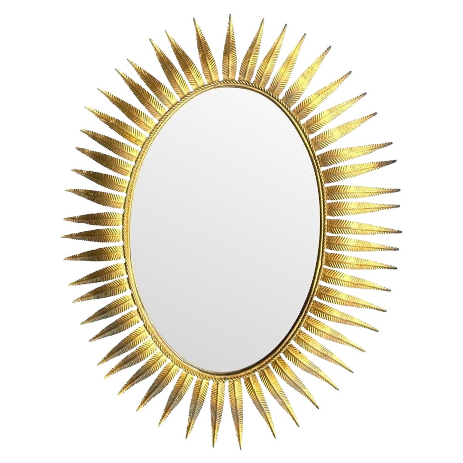 A wonderful 1950s gilt metal oval Spanish sunburst, eyelash mirror For Sale