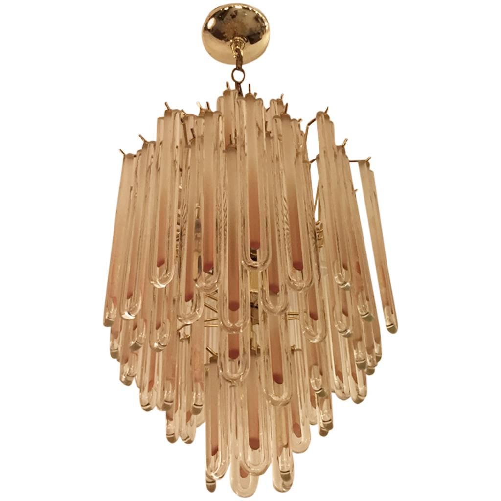 Mid-Century Modern chandelier. Each of the prisms are solid glass. They hang from hooks onto a brass frame, as pictured. Any amount of chain can be added for custom hanging length of the chandelier.