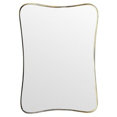 An original Italian 1950s brass framed mirror with shaped curved corners.