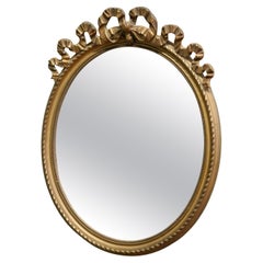 Oval Wall Hanging Gilt Mirror Decorated with Ribbons  A lovely piece