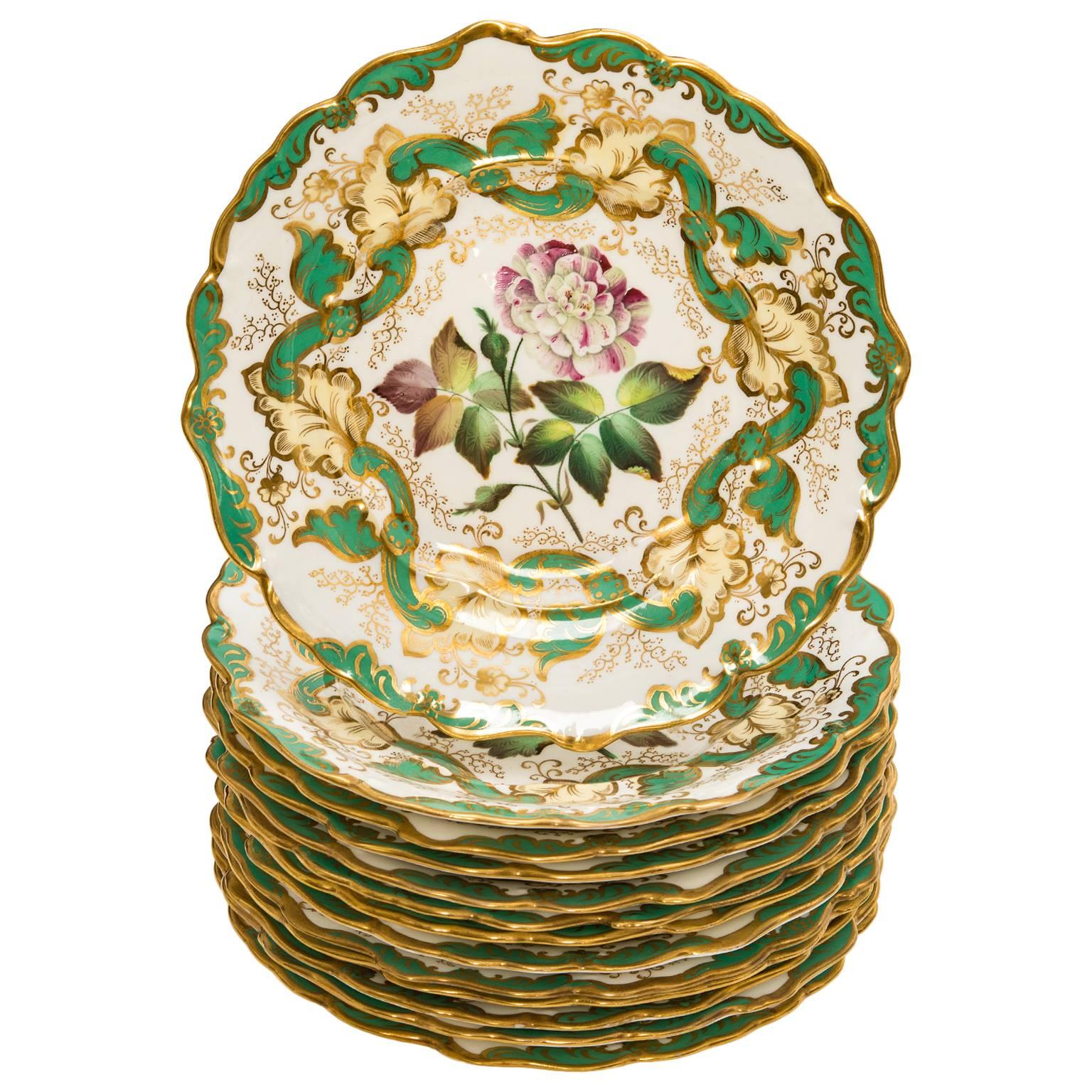 Circa 1840s, England.  This gorgeous mid-nineteenth-century Staffordshire dessert set features hand-painted floral motifs accented by a green and gold border. Elegantly charming, each brightly cheerful piece is decorated with a unique image that