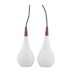 Pair of Louis Poulsen pendants in opal glass and precious wood. 1960s