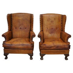 Pair of Patinated Dutch Wingback Cognac Colored Leather Club Chairs