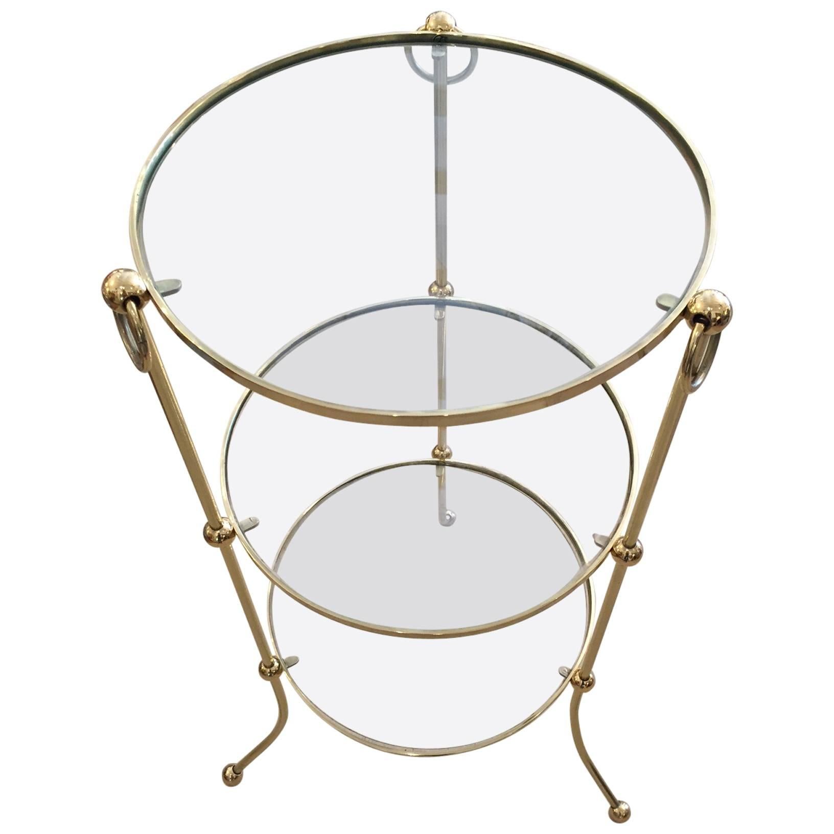 Italian brass circular Campaign style side or drinks table with three tiers for objet d'arte, cocktails, etc. Lovely ball feet and decorative rings.

 