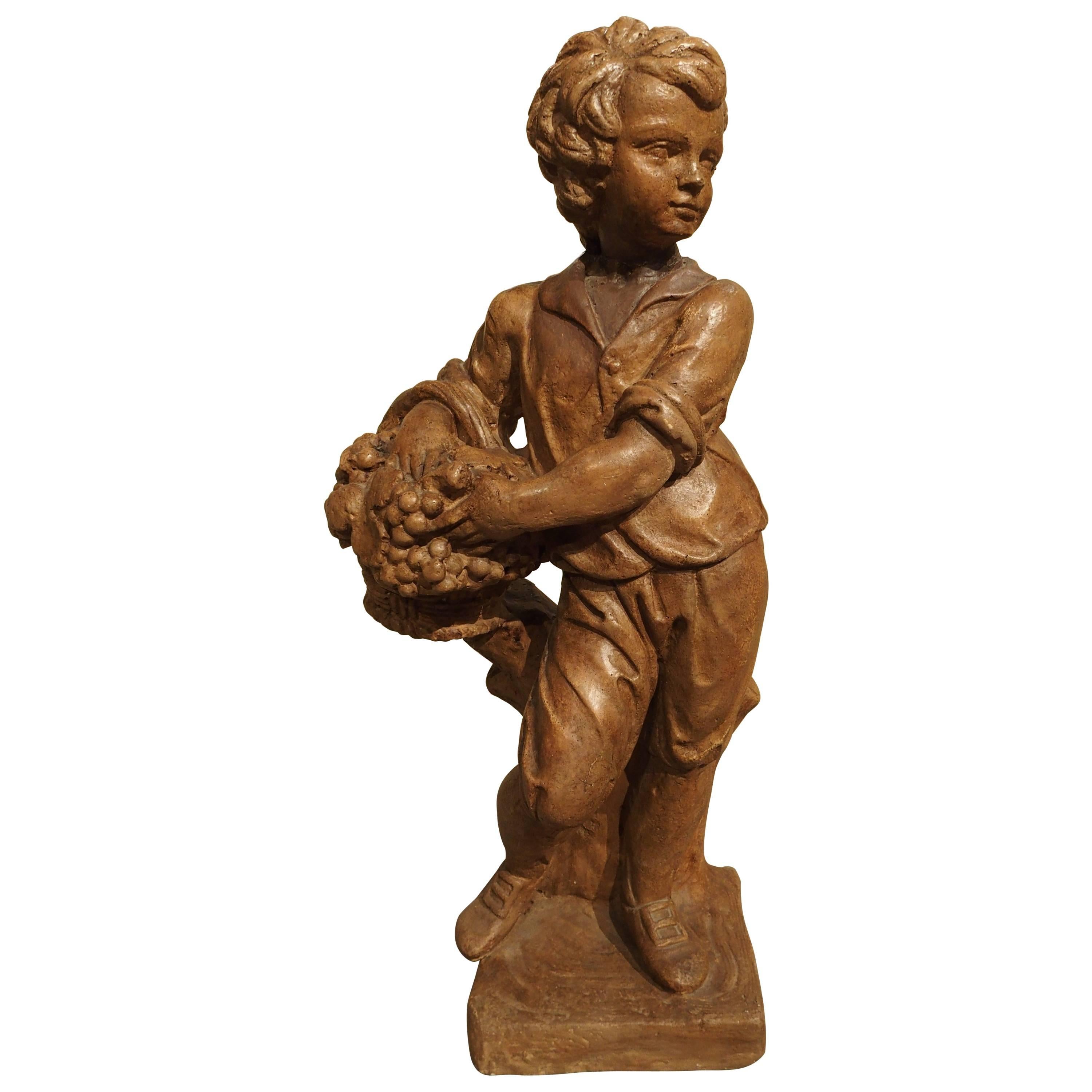 French Vintage Painted Cast Statue of a Boy Holding a Basket of Fruit