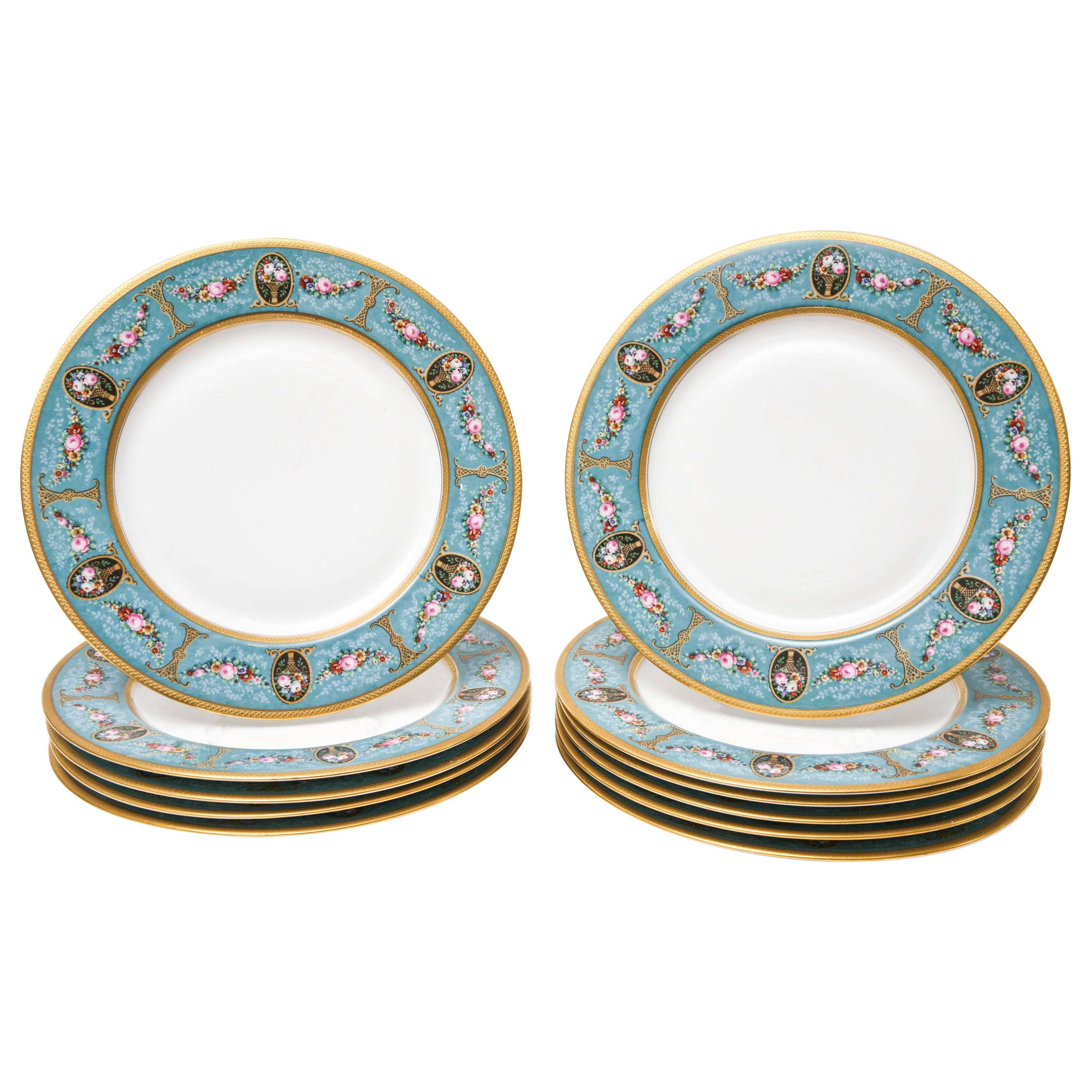 A versatile set of 12 dinner size antique Bavarian plates that feature strong and white bone porcelain, a clear center and charming shoulder decoration of pink garlands of floral, black cartouches on a vibrant turquoise ground. Wonderful antique