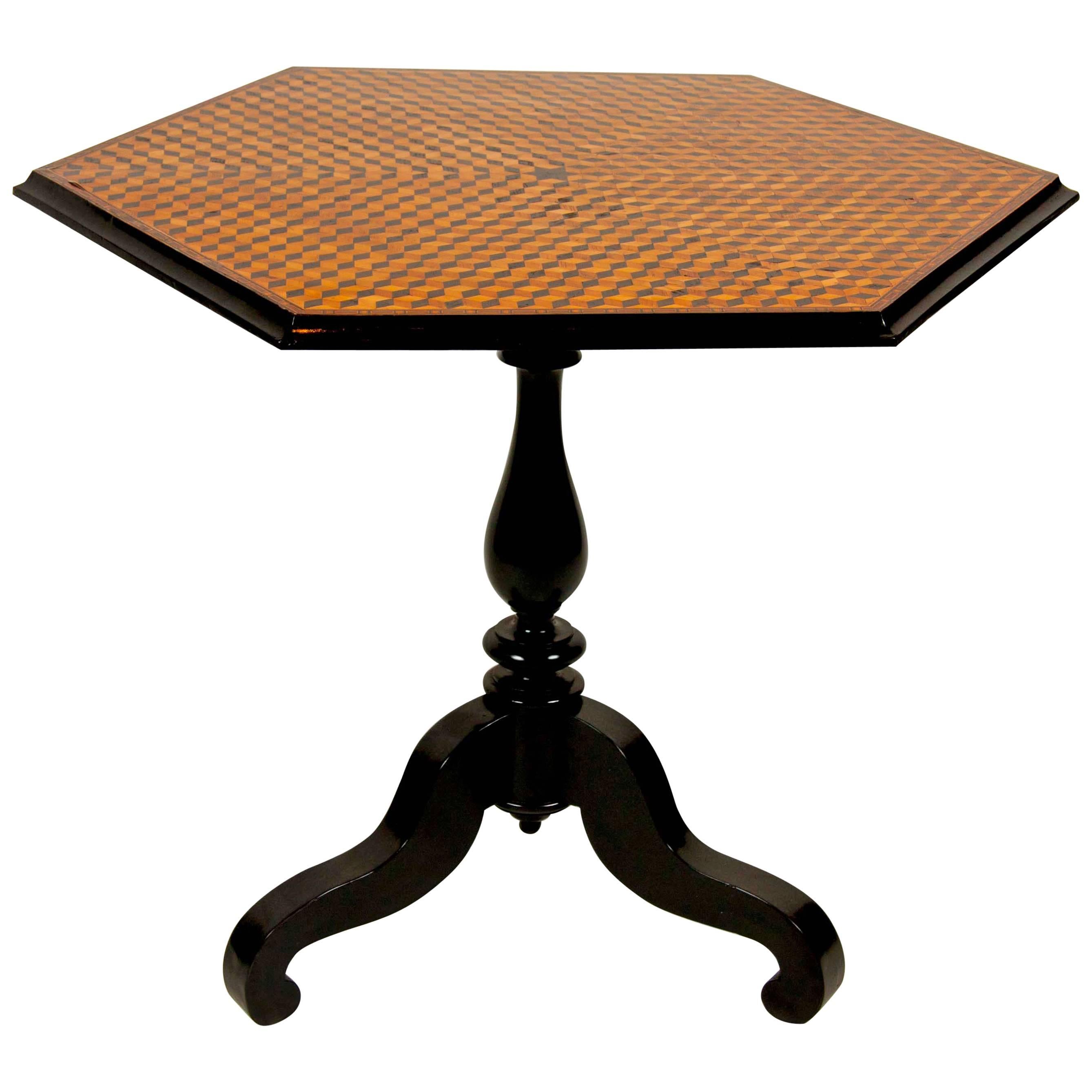 A 19th century American octagonal tilt-top table with ebonized base and cube form inlay. Diameter from point to point = 35.5