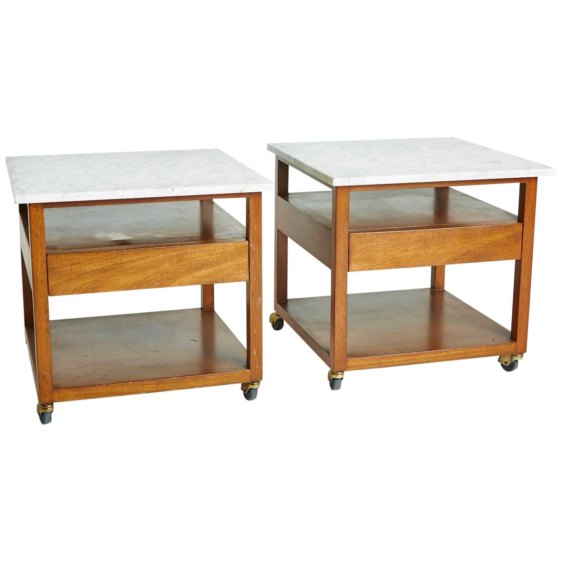 Designed by Harvey Probber, circa 1950s, this pair works perfectly as end tables, side tables, or nightstands. Each table's square wood frames have a small drawer and two platforms for display or storage. The honey-colored wood is an attractive