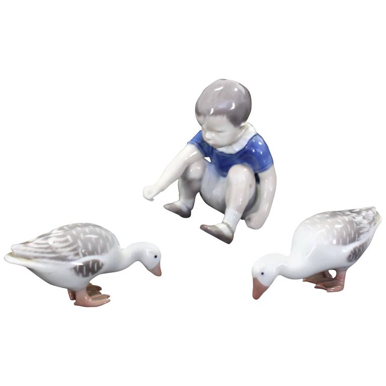 Set of Three Royal Copenhagen Porcelain Figurines "Boy Feeding Geese" For Sale