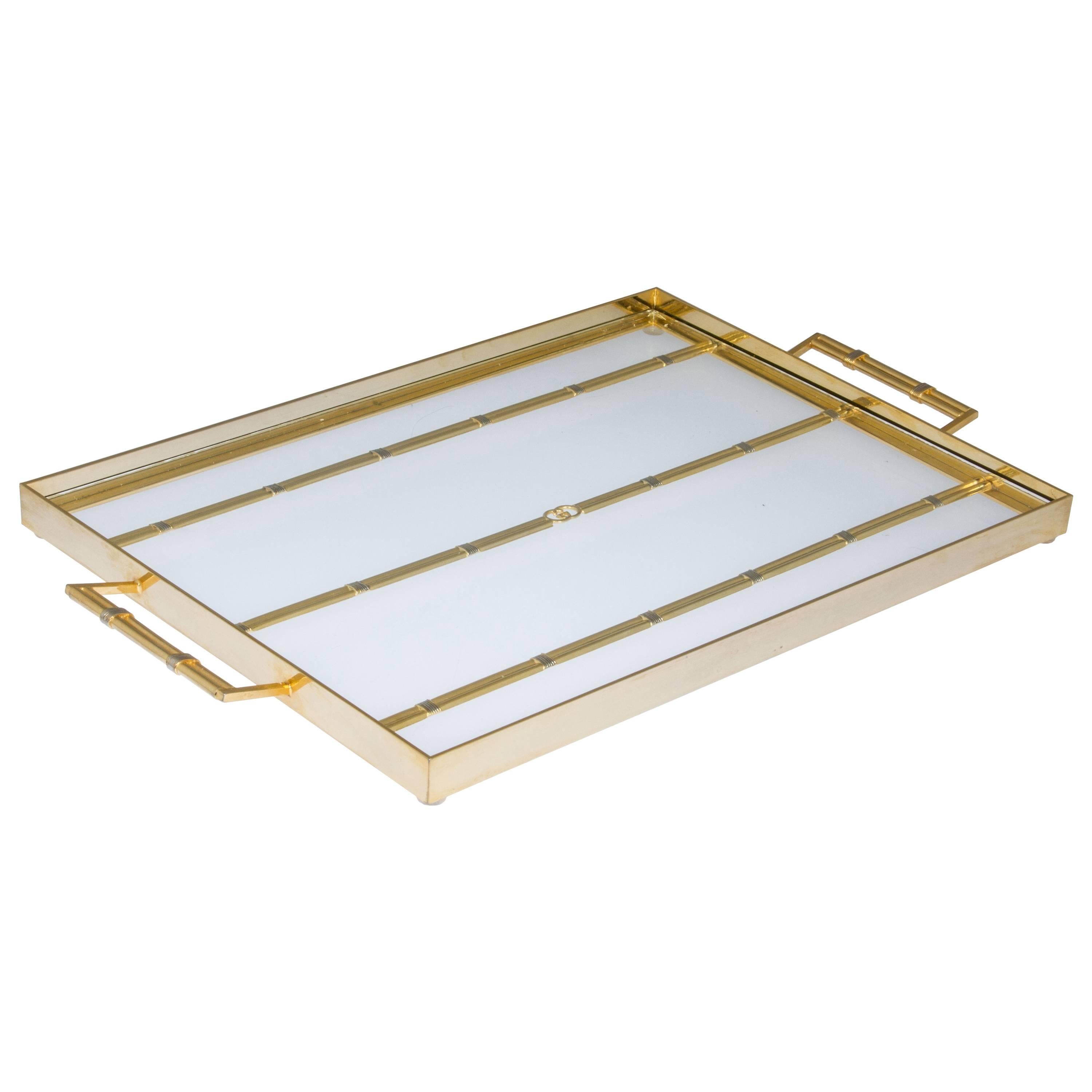 This is a great looking tray having brass accented with silver bands with the Gucci Logo in the center. Great for a vanity, bar or for serving.