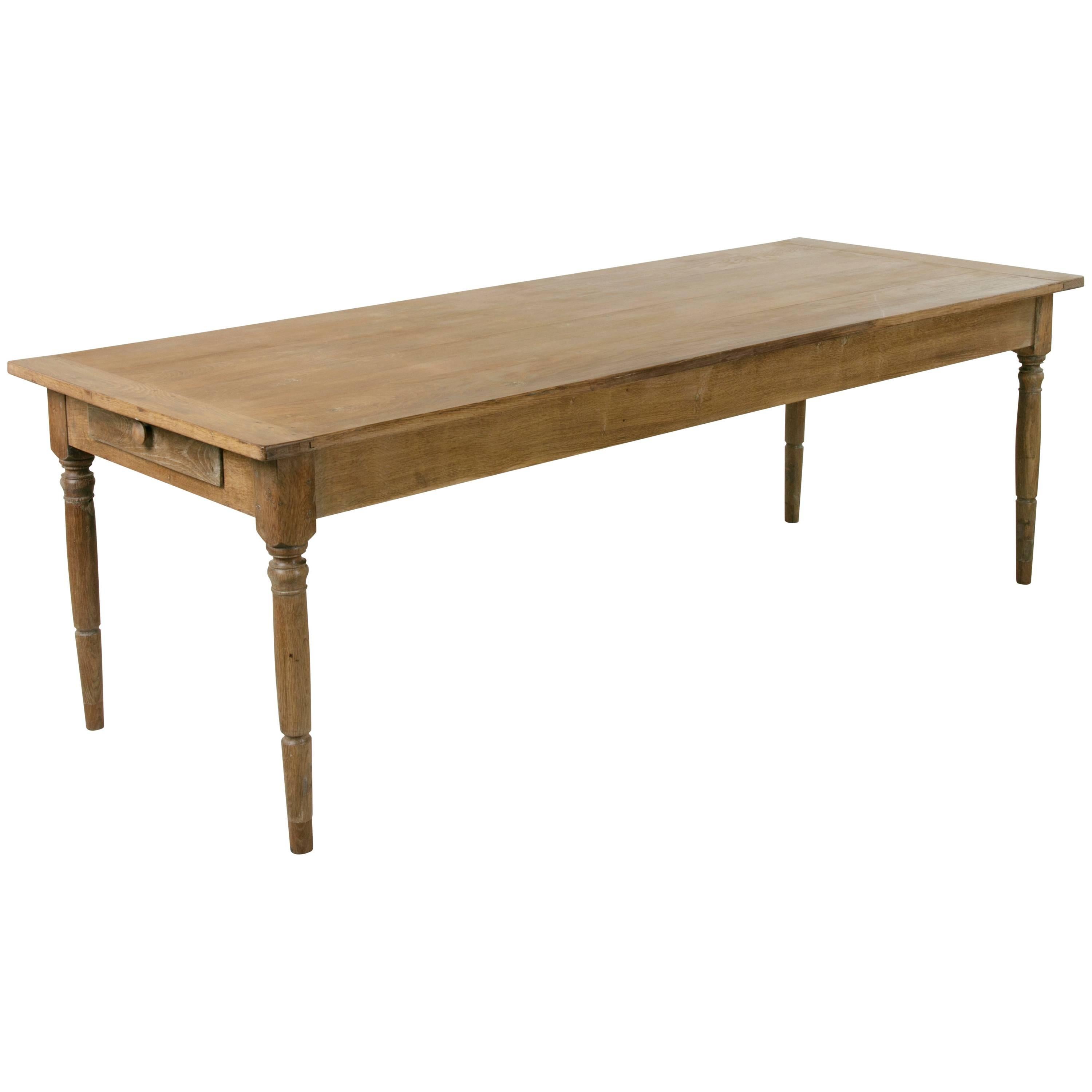 Created by artisans in Normandy, this solid French oak table has a warm aged patina and handsome lines. This piece features turned legs and a single drawer meant to keep bread knives at the table. Designed to last, this expertly made piece will