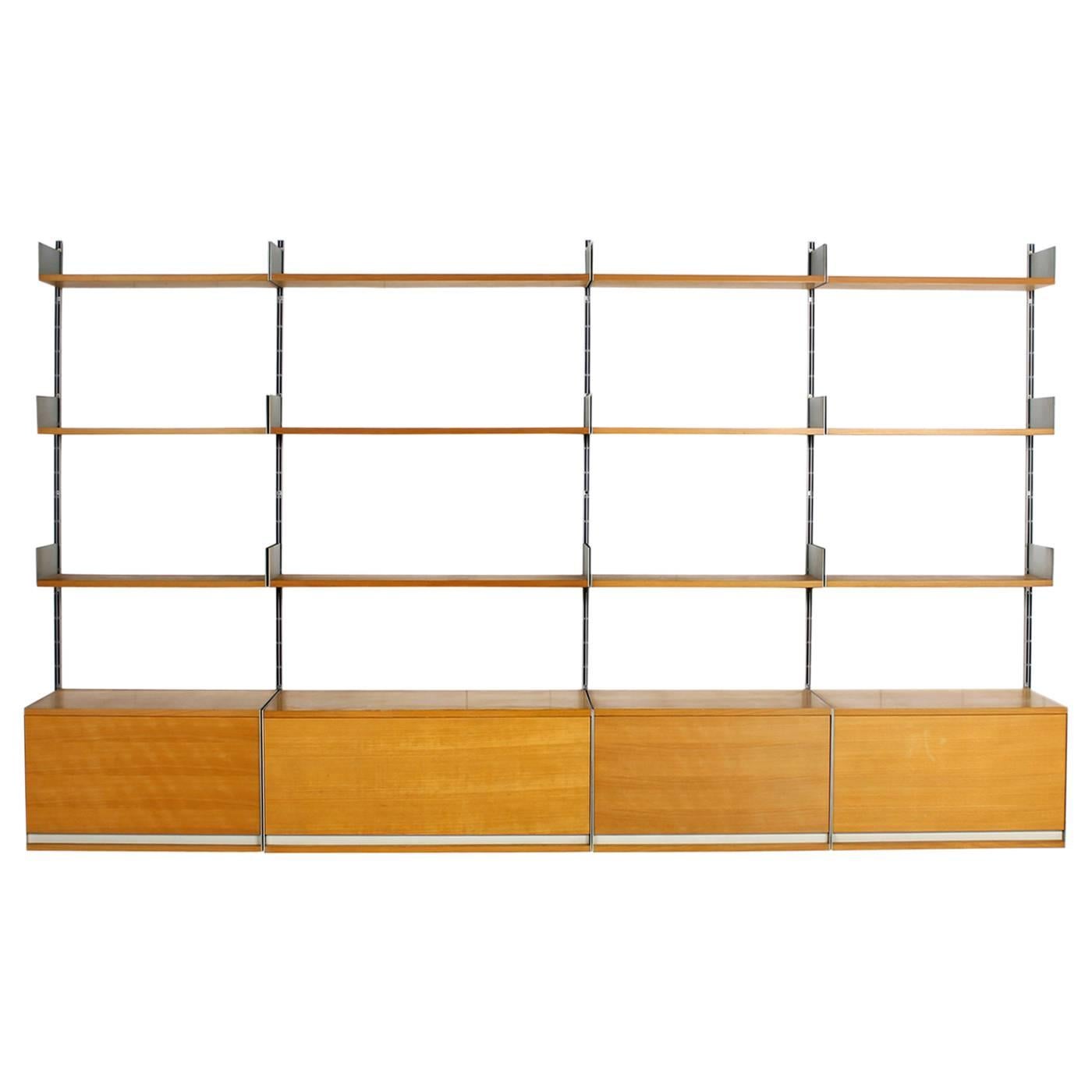 Beautiful vintage, early production in beechwood. Good vintage condition.
One  large cabinet circa 90 x 38 x 38cm, three cabinets circa 66 x 38 x 38cm, three shelves circa 90 x 22cm and nine shelves circa 66 x 22cm. Wall mounts circa 170cm. Total