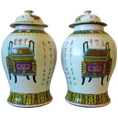 Pair of Chinese Famille Rose Vases and Covers