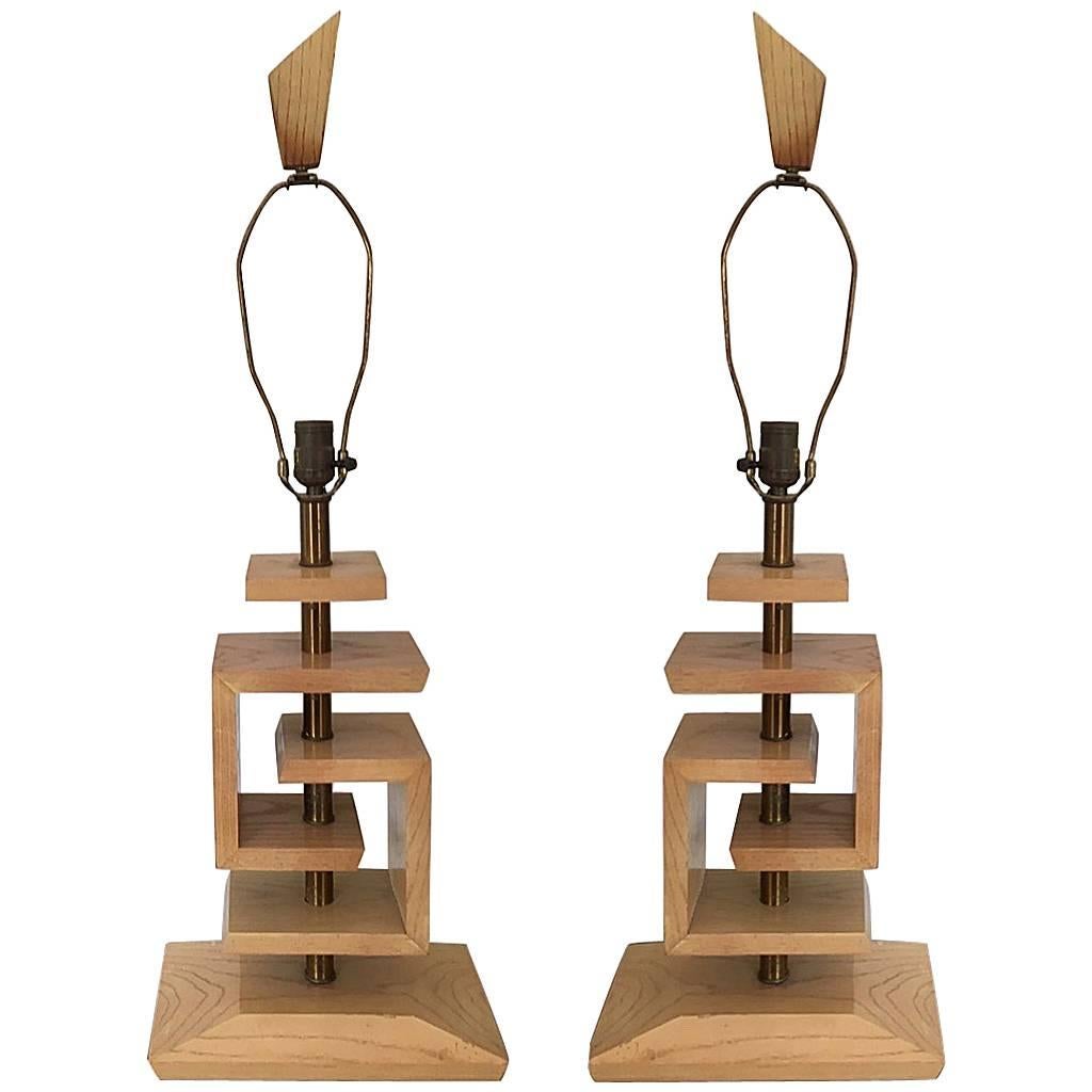 Classic pair of blonde wood and brass lamps with interlocking 'Greek key' design in the style of legendary designer, James Mont.

The pair have had the center rod re-brass plated and now have new silk cord wiring. All you need is a bulb and a