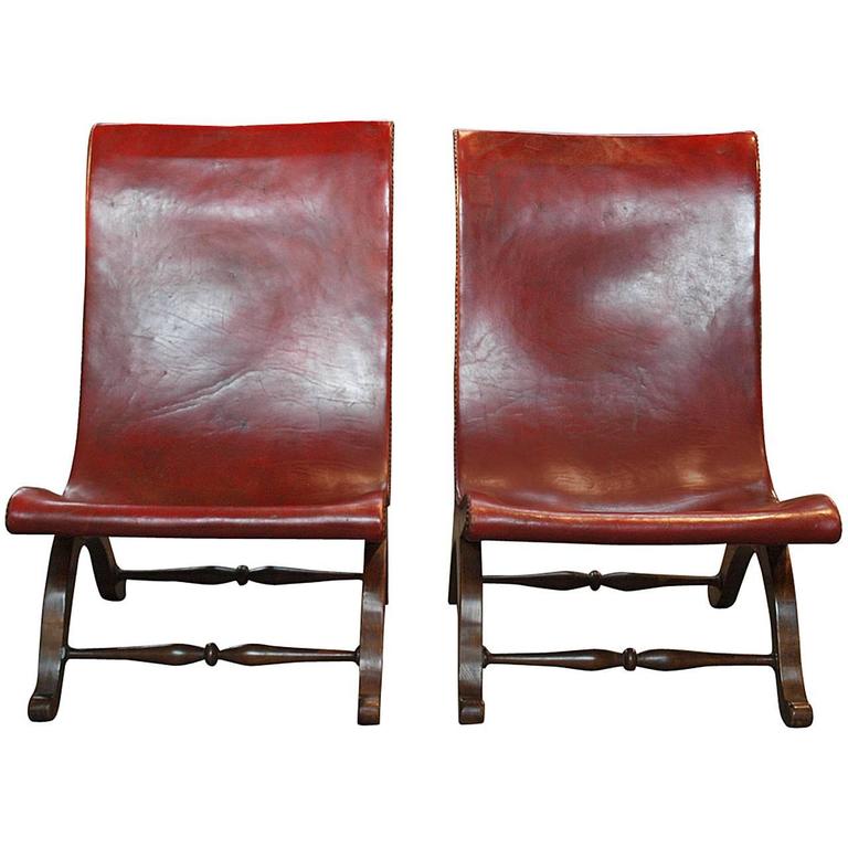 Pair of Spanish low slingback leather slipper chairs, ca. 1920